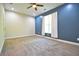 Cozy bedroom featuring plush carpeting, a ceiling fan, and a blue accent wall that creates a peaceful retreat at 191 Fairview Oak Trl, Dallas, GA 30157
