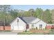 Charming one-story home with gray siding, an attached garage, a well manicured lawn and a red front door at 191 Fairview Oak Trl, Dallas, GA 30157