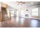 Spacious living room with hardwood floors, staircase, gas fireplace, and view of kitchen, perfect for relaxation at 191 Fairview Oak Trl, Dallas, GA 30157