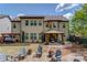 Spacious home backyard features multiple seating areas and a well-manicured lawn at 2631 Moon Chase Lane, Buford, GA 30519