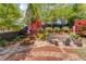 Beautifully landscaped backyard with stone patio, firepit, and picnic table at 2631 Moon Chase Lane, Buford, GA 30519