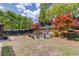 Expansive backyard with stone patio and fire pit surrounded by lush landscaping and mature trees at 2631 Moon Chase Lane, Buford, GA 30519