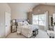A calming bedroom is styled with a chandelier and soft, neutral color palette at 2631 Moon Chase Lane, Buford, GA 30519