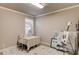 Cozy bedroom with a sewing table, art supplies and a neutral color scheme at 2631 Moon Chase Lane, Buford, GA 30519