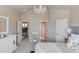 Open bedroom view features a white dresser, chandelier, and views of a stairway at 2631 Moon Chase Lane, Buford, GA 30519