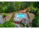 Aerial view of a community pool with lounge chairs and surrounded by trees at 2631 Moon Chase Lane, Buford, GA 30519