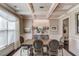 Formal dining room with wainscoting, coffered ceilings, elegant lighting, and neutral decor at 2631 Moon Chase Lane, Buford, GA 30519
