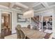 Formal dining room with wainscoting, coffered ceilings, elegant lighting, and neutral decor at 2631 Moon Chase Lane, Buford, GA 30519