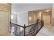 Hallway boasts a contemporary chandelier and decorative wall art leading to a staircase with iron railings and wood accents at 2631 Moon Chase Lane, Buford, GA 30519