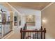 Upstairs hallway with wood staircase and arched entrance at 2631 Moon Chase Lane, Buford, GA 30519