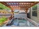 Relax in this outdoor hot tub with a wooden pergola for shade and privacy at 2631 Moon Chase Lane, Buford, GA 30519