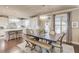 Bright, white kitchen featuring a dining area with stylish chandelier and seating at 2631 Moon Chase Lane, Buford, GA 30519