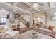 Spacious living room featuring hardwood floors, coffered ceilings, and an open floor plan at 2631 Moon Chase Lane, Buford, GA 30519