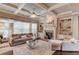 Bright living room with coffered ceilings, hardwood floors, fireplace, and custom built-ins at 2631 Moon Chase Lane, Buford, GA 30519