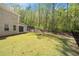 Spacious backyard offering serene views, a covered porch, and potential for outdoor enjoyment at 2890 Canter Meadow Dr, Cumming, GA 30040