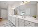 Elegant bathroom featuring double vanities with sleek countertops and modern lighting at 2890 Canter Meadow Dr, Cumming, GA 30040