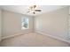Neutral-toned bedroom featuring a ceiling fan and a sunlit window at 2890 Canter Meadow Dr, Cumming, GA 30040
