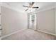 Simple bedroom with neutral tones, ceiling fan, plush carpeting, and great natural light at 2890 Canter Meadow Dr, Cumming, GA 30040