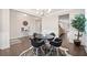 Open-concept dining area with dark hardwood floors, white wainscoting, and modern decor at 2890 Canter Meadow Dr, Cumming, GA 30040