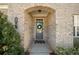 Close-up of a home's front door with a wreath and brick archway at 2890 Canter Meadow Dr, Cumming, GA 30040