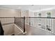 Second floor hallway featuring hardwood floors, wood banister, and great lighting at 2890 Canter Meadow Dr, Cumming, GA 30040