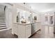 Spacious kitchen island featuring white cabinetry, granite countertops, and an open view to living areas at 2890 Canter Meadow Dr, Cumming, GA 30040