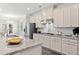Bright kitchen featuring white cabinets, granite countertops, stainless steel appliances, and stylish finishes at 2890 Canter Meadow Dr, Cumming, GA 30040
