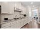 Modern kitchen with white cabinets, granite countertops, and stainless steel appliances at 2890 Canter Meadow Dr, Cumming, GA 30040
