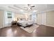 Luxurious main bedroom with hardwood floors, tray ceiling, and stylish decor at 2890 Canter Meadow Dr, Cumming, GA 30040