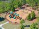 Community playground with swings, slides, and climbing structures, surrounded by lush greenery at 2890 Canter Meadow Dr, Cumming, GA 30040