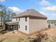 Rear exterior view of home with a spacious backyard and screened-in porch, perfect for outdoor living at 2890 Canter Meadow Dr, Cumming, GA 30040
