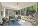 Inviting screened porch with outdoor seating offers a peaceful view of the wooded backyard at 2890 Canter Meadow Dr, Cumming, GA 30040