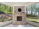 Charming screened porch with a cozy brick fireplace and serene views of the landscaped backyard at 2890 Canter Meadow Dr, Cumming, GA 30040