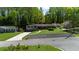 Aerial view of the house with a long driveway, black rock landscaping, and mature trees at 2920 Dara Dr, Marietta, GA 30066