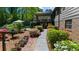 Well-manicured backyard landscaping leading to the screened in porch, an umbrella, and a well-maintained lawn at 2920 Dara Dr, Marietta, GA 30066