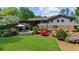 Expansive backyard with a screened porch, lush lawn, mature landscaping, and patio area at 2920 Dara Dr, Marietta, GA 30066