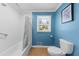 Clean, bright bathroom with a white tiled tub and shower, and a toilet with storage at 2920 Dara Dr, Marietta, GA 30066