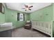 Charming Bedroom with green walls, a crib, gray chair and cheerful hot air balloon decals at 2920 Dara Dr, Marietta, GA 30066