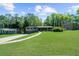 Charming home featuring a long driveway, lush front lawn, and mature landscaping at 2920 Dara Dr, Marietta, GA 30066
