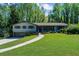 Charming one-story home with a well-maintained lawn and inviting walkway surrounded by mature trees at 2920 Dara Dr, Marietta, GA 30066