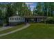 Charming one-story home with a well-maintained lawn and inviting walkway surrounded by mature trees at 2920 Dara Dr, Marietta, GA 30066