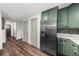 Hallway with hardwood floors, a stainless steel refrigerator and neutral colored walls at 2920 Dara Dr, Marietta, GA 30066