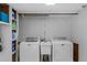 Basement laundry room features a utility sink, washer and dryer and open shelving at 2920 Dara Dr, Marietta, GA 30066