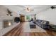 Cozy living room with brick fireplace, ceiling fan, hardwood floors, and comfortable blue sectional sofa at 2920 Dara Dr, Marietta, GA 30066