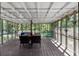 Spacious screened porch with wood decking, comfortable seating, and view of natural surroundings at 2920 Dara Dr, Marietta, GA 30066