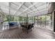 Inviting screened porch with wood decking, ample seating, and view of natural surroundings at 2920 Dara Dr, Marietta, GA 30066