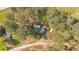 An aerial view of a home surrounded by many tall trees and a long driveway at 5400 Kings Camp Cabin 16 Se Rd, Acworth, GA 30102