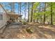 Backyard featuring the home's covered porch and mature tree coverage at 5400 Kings Camp Cabin 16 Se Rd, Acworth, GA 30102