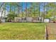 Exterior shot of property with large yard and storage shed at 5400 Kings Camp Cabin 16 Se Rd, Acworth, GA 30102