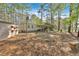 View of the home featuring a large yard, mature trees, and an inviting covered porch at 5400 Kings Camp Cabin 16 Se Rd, Acworth, GA 30102